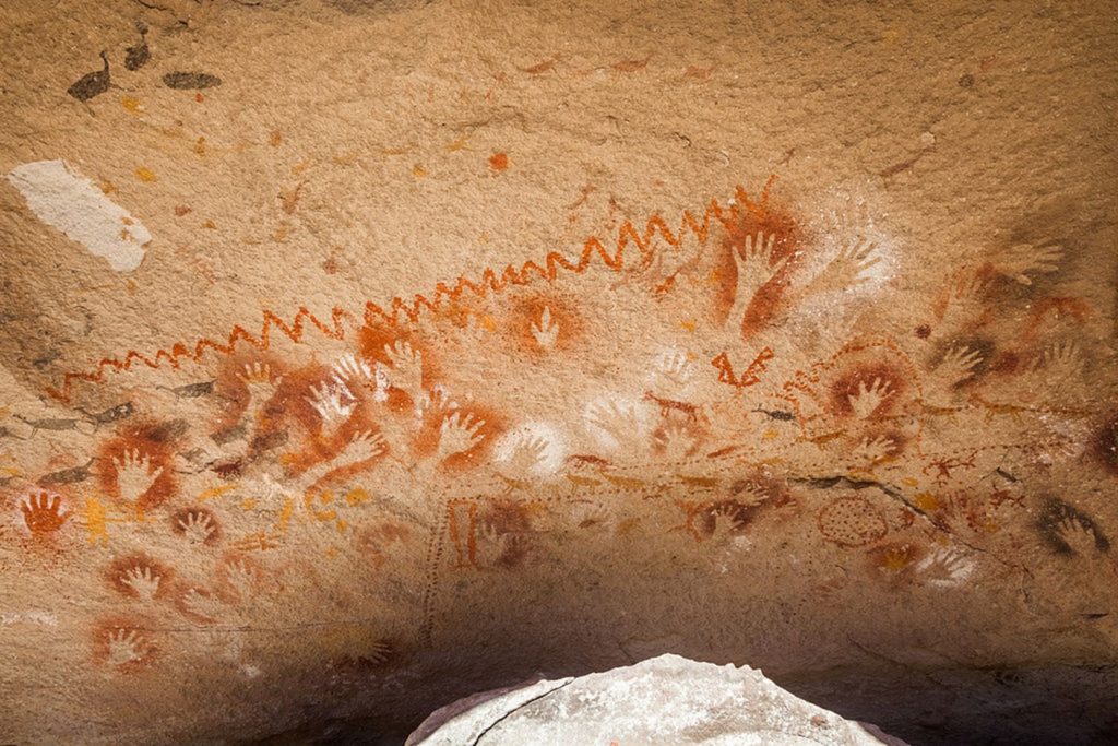Cave of Hands. Left to right: animal feet, human hands, and geometric patterns 