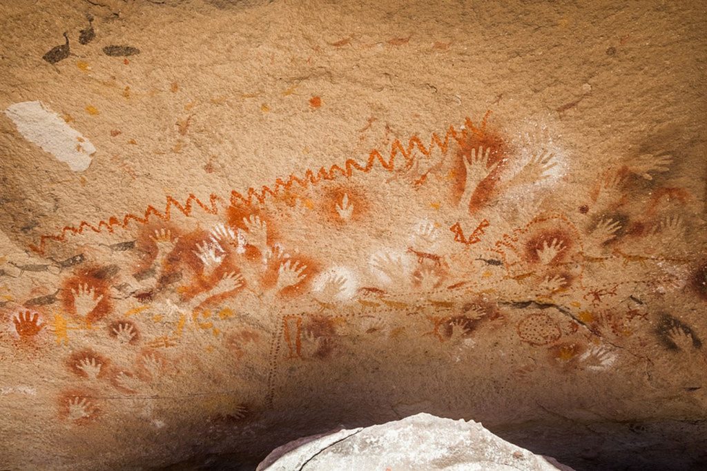 Cave of Hands. Left to right: animal feet, human hands, and geometric patterns