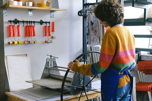 Artist preparing the press for printing. 